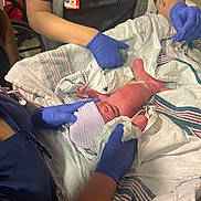 Colton joined the competition — help win amazing prizes! newborn, baby, medical_staff, hospital, gloves, blanket, hat, umbilical_cord, patient_care, healthcare, person, medical_equipment, bed, treatment, nursery, clinic, newborn_care, delivery_room, human, infant