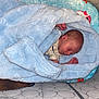 Colton joined the competition — help win amazing prizes! baby, bed, blanket, blue, clothing, comfort, cozy, crib, face, head, indoors, infant, newborn, peaceful, person, rest, sleeping, soft, wrapped, young