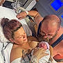 newborn, baby, mother, father, hospital_bed, iv_drip, tattoos, blanket, medical_equipment, love, family, intimacy, man, woman, beard, glasses, hospital_room, bed, patient, new_life