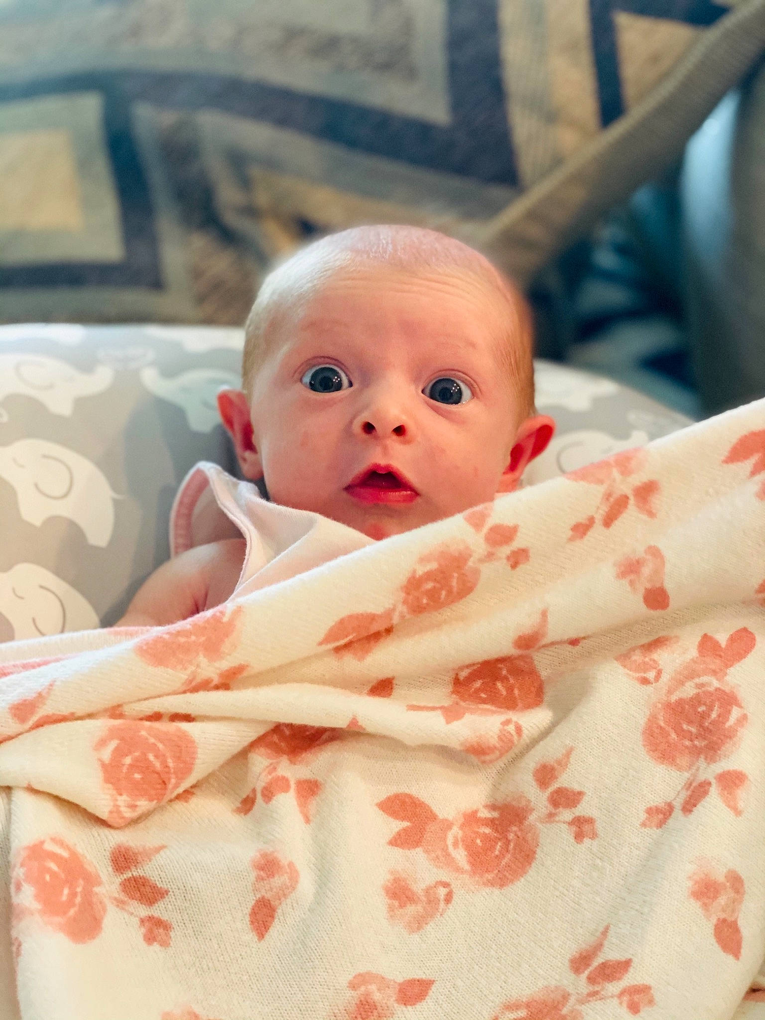 Adelina is registered to the contest to win money with this photo: baby, baby_products, baby_toddler_clothing, bed_sheet, bedding, cheek, child, chin, comfort, eye, face, happy, head, iris, linens, person, pink, skin, sleeve, surprise