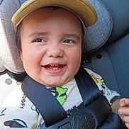 Yael De Leon joined the competition — help win amazing prizes! toddler, child, smiling, car_seat, safety_harness, cap, yellow_cap, happy, cute, baby, face, portrait, seat, clothing, closeup, daylight, indoors, person, infant, seatbelt