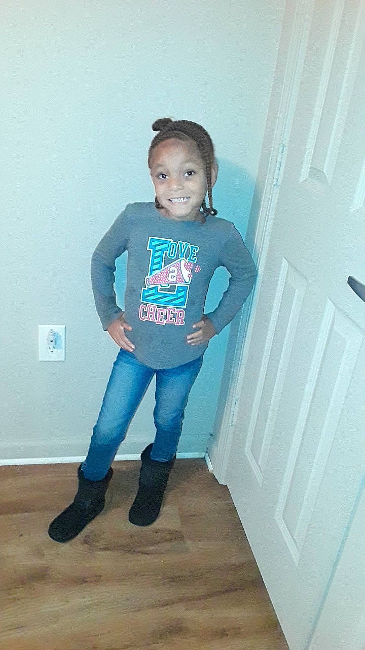 Ashanti is registered to the contest to win money with this photo: blue, child, clothing, cool, day, electric_blue, footwear, fun, girl, jeans, joy, leg, material, outerwear, person, product, shoulder, standing, t_shirt, textile