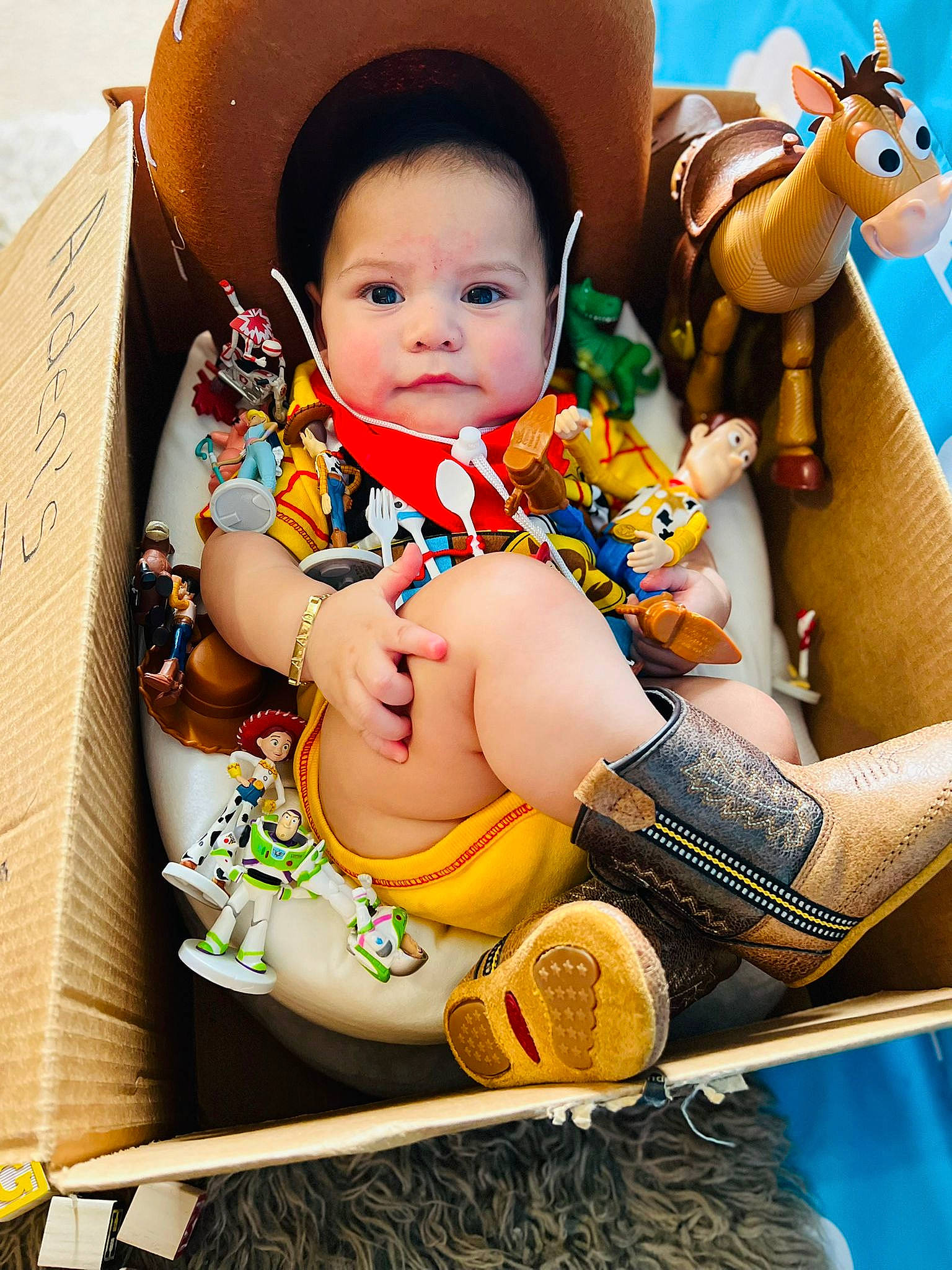 Aiden is registered to the contest to win money with this photo: abdomen, baby, baby_products, baby_toddler_clothing, child, fun, happy, hat, human_body, human_leg, lap, leisure, person, play, recreation, sitting, skin, thigh, toddler, travel