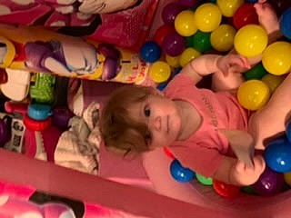 Fiona is registered to the contest to win money with this photo: baby, baby_toys, ball_pit, child, fun, leisure, person, play, product, smile, toddler, toy