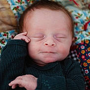 Cooper joined the competition — help win amazing prizes! baby, blanket, calm, child, closeup, cozy, eyes_closed, face, floral, hand, indoors, infant, knitwear, lying_down, newborn, patterned, photography, portrait, sleeping, sweater