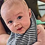 Cohen joined the competition — help win amazing prizes! baby, infant, face, eyes, bib, striped_clothing, skin, person, cute, child, portrait, human, hand, expression, young, holding, indoor, closeup, head, smile