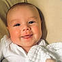 Cohen joined the competition — help win amazing prizes! baby, infant, smiling, tongue_out, blanket, white_clothing, couch, cushion, face, hand, cheeks, indoors, portrait, cute, soft_texture, happy, child, person, closeup, resting