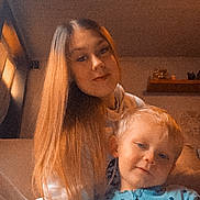 Aëden participe au concours pour gagner de l'argent avec cette photo : child, woman, indoor, pajamas, long_hair, portrait, cozy, family, candid, smile, blond, young, casual_clothing, relaxed, home, sitting, face, toddler, two_people, warm_lighting