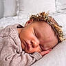 baby, newborn, sleeping, face, head, knitted_sweater, flower_crown, pillow, soft_texture, cozy, resting, peaceful, infant, closeup, portrait, cute, toddler, homedecor, blanket, skin