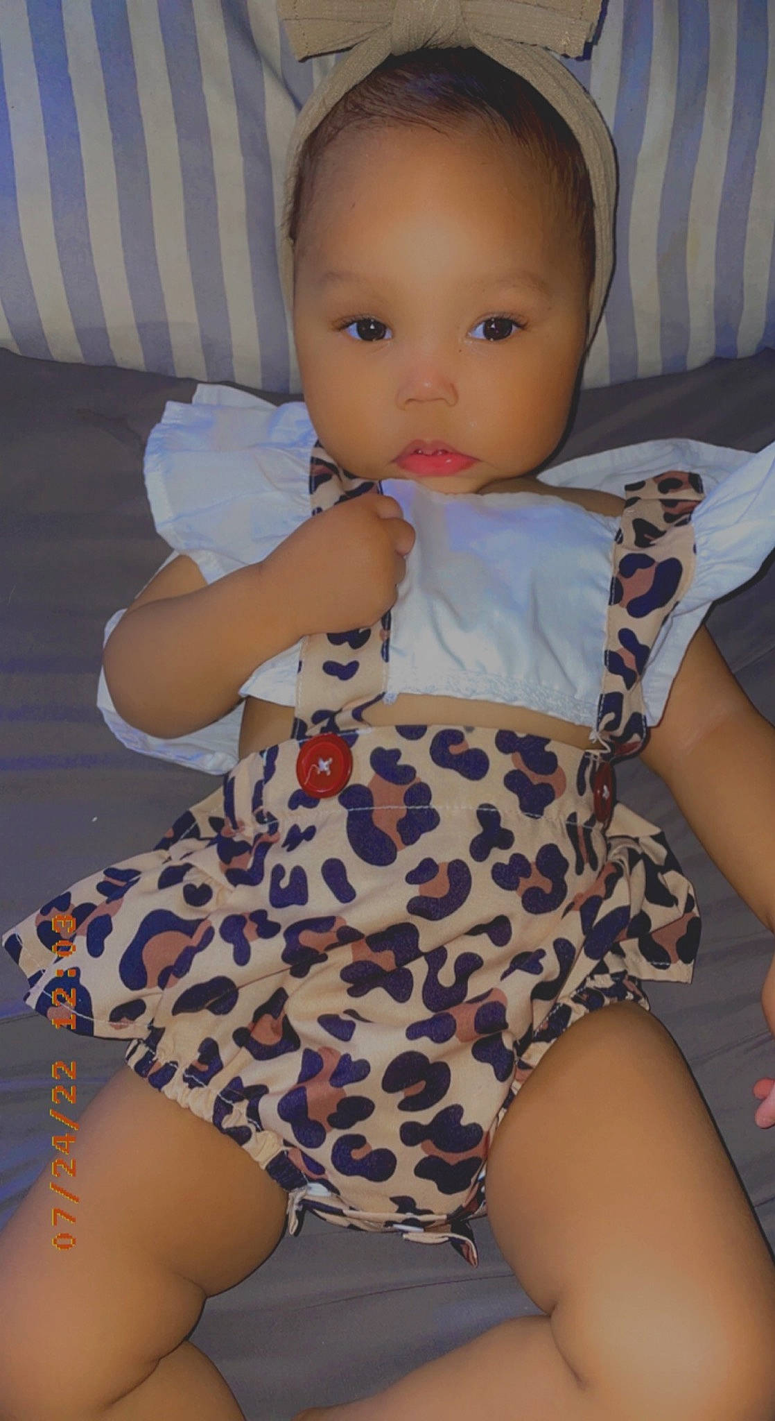 Adelynn is registered to the contest to win money with this photo: arm, baby_toddler_clothing, comfort, dress, finger, hairstyle, hand, head, human_body, joint, knee, leg, lip, neck, organ, person, shoulder, skin, sleeve, textile