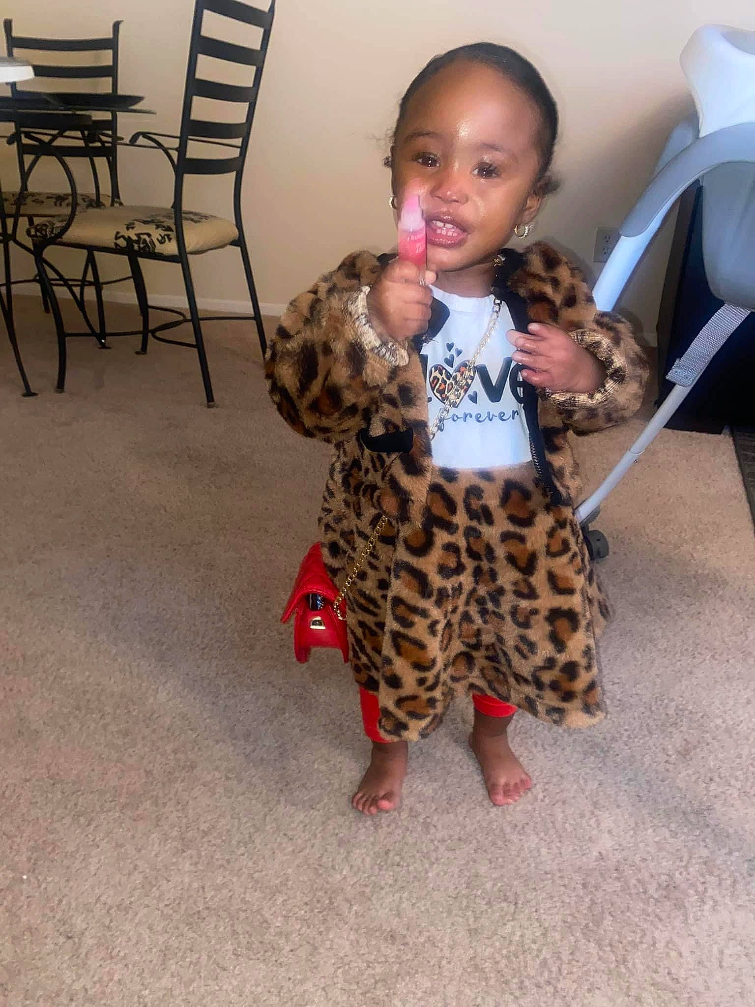 Cori is registered to the contest to win money with this photo: baby, baby_toddler_clothing, chair, fashion_design, fawn, felidae, floor, flooring, fur, joint, leg, long_hair, neck, pattern, person, shoulder, sitting, skin, sleeve, toddler