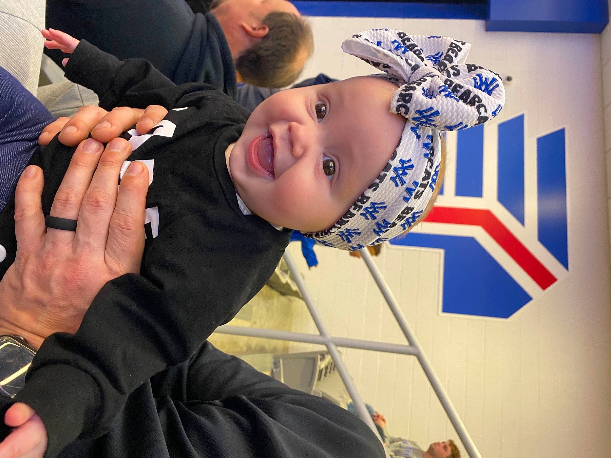 Georgia Kate is registered to the contest to win money with this photo: arm, baby, child, elbow, electric_blue, event, eyewear, fashion_accessory, finger, fun, gesture, hand, happy, headwear, jewellery, leisure, nail, person, smile, thumb