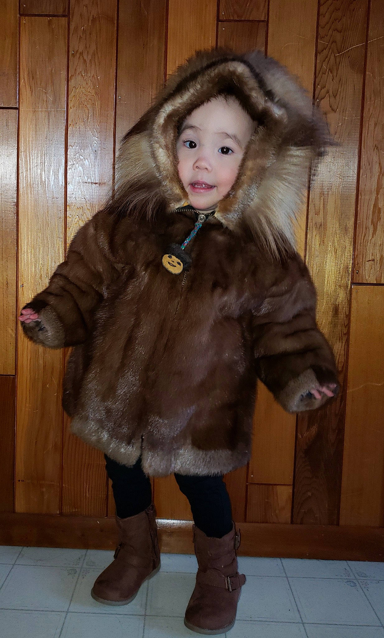 Anya is registered to the contest to win money with this photo: brown_hair, clothing, coat, costume, fur, fur_clothing, outerwear, person, textile