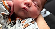 Kaden is registered to the contest to win money with this photo: baby, baby_clothes, cartoon_characters, child, closeup, cozy, cute, hand, holding, infant, newborn, newborn_baby, onesie, peaceful, person, portrait, resting, sleep, sleeping, soft_light