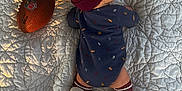 Callahan joined the competition — help win amazing prizes! baby, infant, football, nfl, onesie, hat, beanie, socks, quilt, bed, lying_down, child, sport, pattern, textile, indoor, cute, soft, small, resting