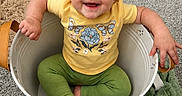 Amber joined the competition — help win amazing prizes! baby, blanket, bucket, carpet, child, cozy, cute, face, foot, green_pants, hand, happy, home, indoor, portrait, sitting, smiling, toddler, toy, yellow_shirt