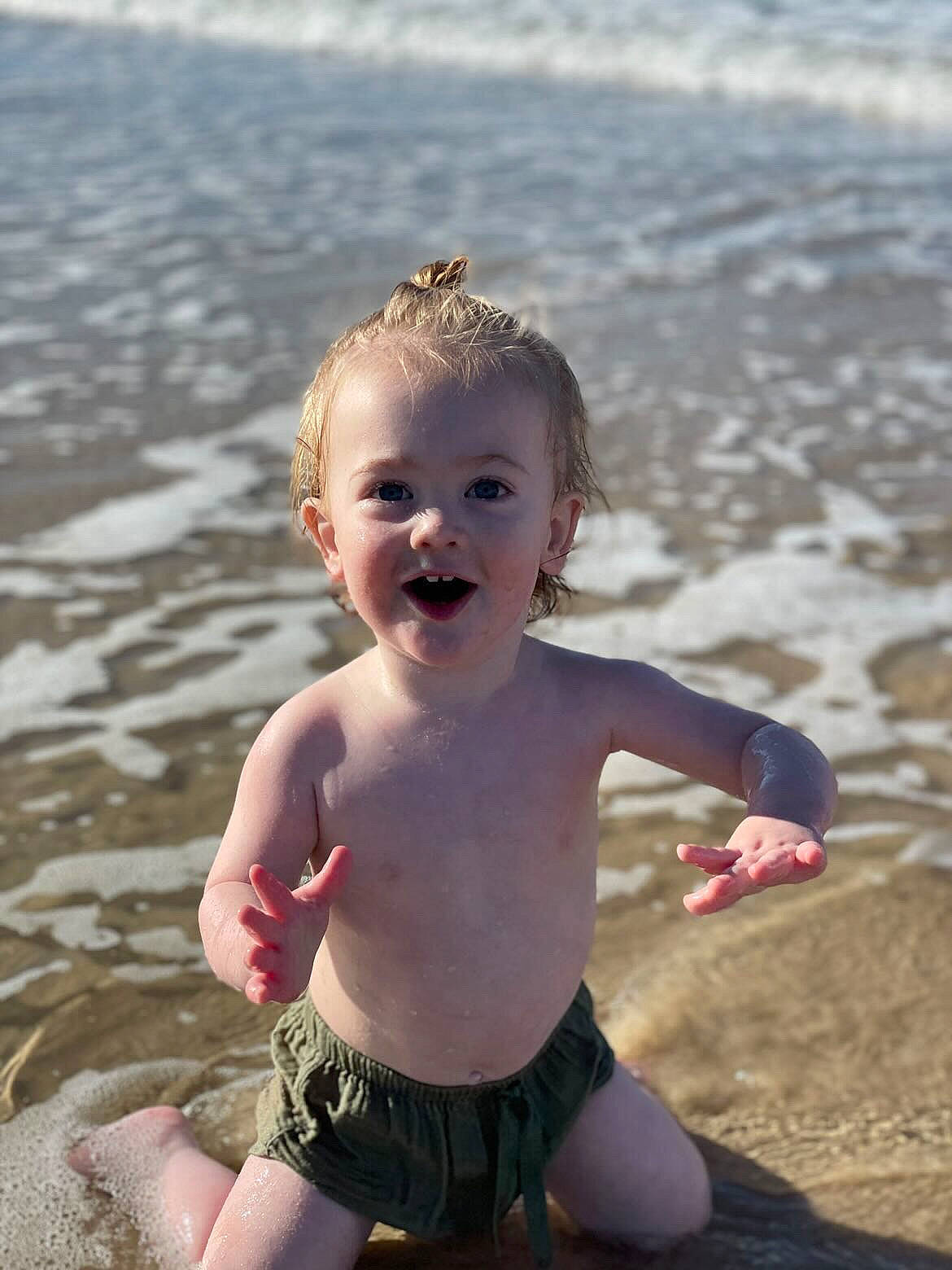 Khylan joined the competition — help win amazing prizes! baby, baby_toddler_clothing, beach, body_of_water, chest, child, flash_photography, fun, happy, human_body, people_in_nature, people_on_beach, person, photograph, sand, sitting, smile, summer, toddler, trunk
