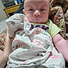 Owen joined the competition — help win amazing prizes! baby, infant, blanket, drool, face, head, hand, person, indoors, furniture, table, clothing, skin, portrait, child, newborn, expression, holding, comfort, cozy