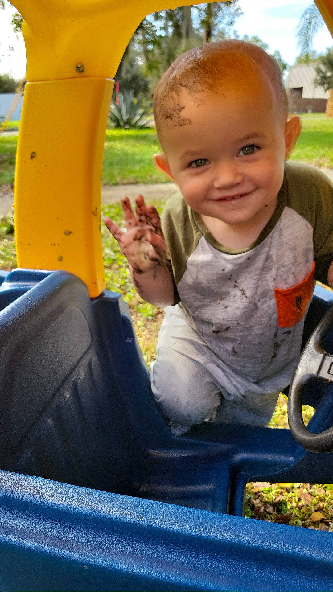 Tyler is registered to the contest to win money with this photo: automotive_tire, baby_toddler_clothing, cool, face, facial_expression, finger, fun, grass, green, happy, joy, leaf, leisure, morning, person, photograph, plant, product, smile, summer