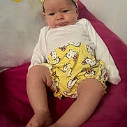 Annabella joined the competition — help win amazing prizes! baby, infant, headband, yellow, hello_kitty, clothing, shorts, blanket, pink, person, face, legs, feet, cute, expression, indoors, sitting, child, apparel, soft_fabric