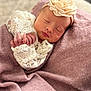 newborn, baby, sleeping, lace, headband, flower, blanket, soft_texture, peaceful, portrait, infant, cute, closeup, wrapped, delicate, hands, face, cozy, resting, indoors