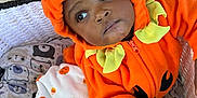 Dakari is registered to the contest to win money with this photo: baby, child, costume, pumpkin, orange, blanket, basket, hand, face, clothing, cute, infant, expression, wall, indoor, fabric, pattern, leaf, autumn, holiday