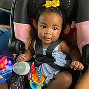 Charm Ross joined the competition — help win amazing prizes! baby, child, car_seat, toy, bottle, headband, minnie_mouse_ears, yellow_bow, sitting, curious, black_hair, blue_outfit, sock, infant, seat_belt, indoors, cute, face, portrait, closeup