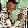 Charm Ross joined the competition — help win amazing prizes! baby, child, infant, curly_hair, onesie, socks, mickey_mouse, baby_seat, colorful, patterned_fabric, smiling_face_pattern, relaxed, indoor, cute, small_hand, bracelet, seated, portrait, young_child, comfort