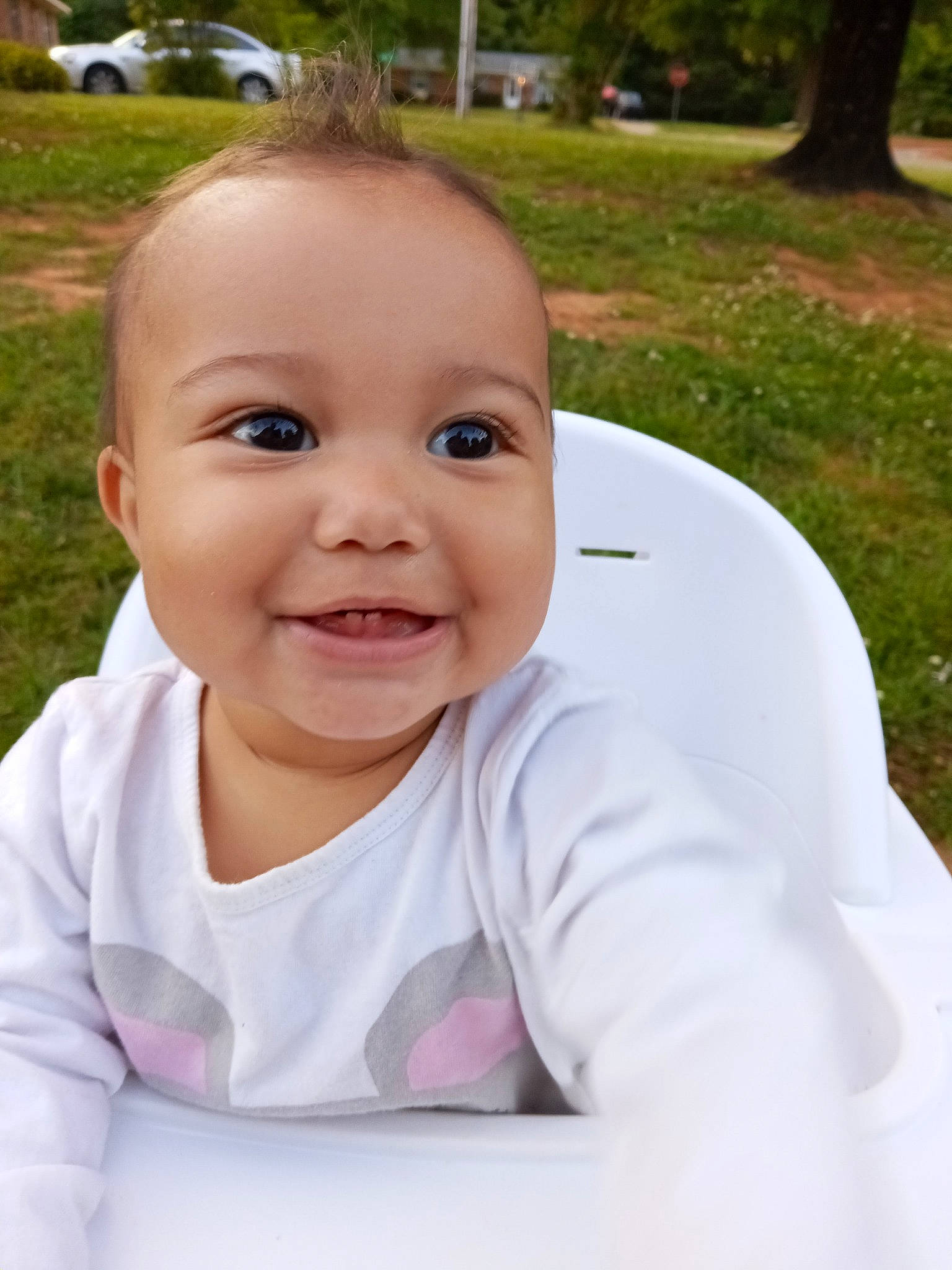 Emberly is registered to the contest to win money with this photo: arm, baby, baby_toddler_clothing, cheek, chin, eyebrow, facial_expression, grass, hairstyle, happy, iris, joy, lip, mouth, nose, people_in_nature, person, plant, skin, sleeve