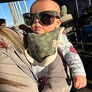 Makaio joined the competition — help win amazing prizes! baby, sunglasses, bib, person, hoodie, indoor, child, spiderman, pajamas, hand, face, sunlight, people, chair, clothing, holding, portrait, cool, casual, cute