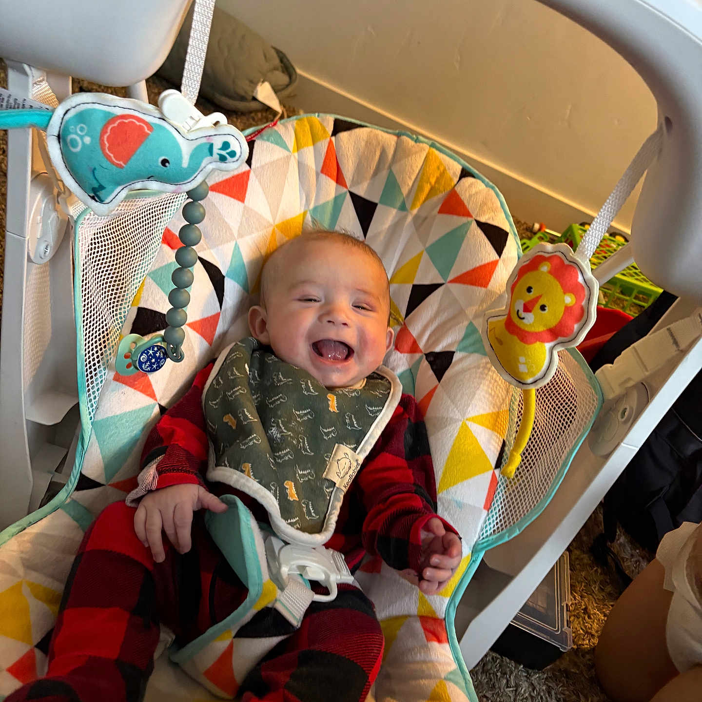 Makaio is registered to the contest to win money with this photo: baby, baby_rocker, bib, carpet, child, colorful, comfort, cute, fabric, happy, indoor, infant, laughing, person, plaid_clothing, playful, seat, smiling, toy_elephant, toy_lion