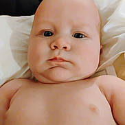 Joseph is registered to the contest to win money with this photo: baby, child, infant, face, skin, eyes, expression, closeup, portrait, naked_torso, lying_down, soft_light, head, young, cute, indoors, person, human, chubby, newborn