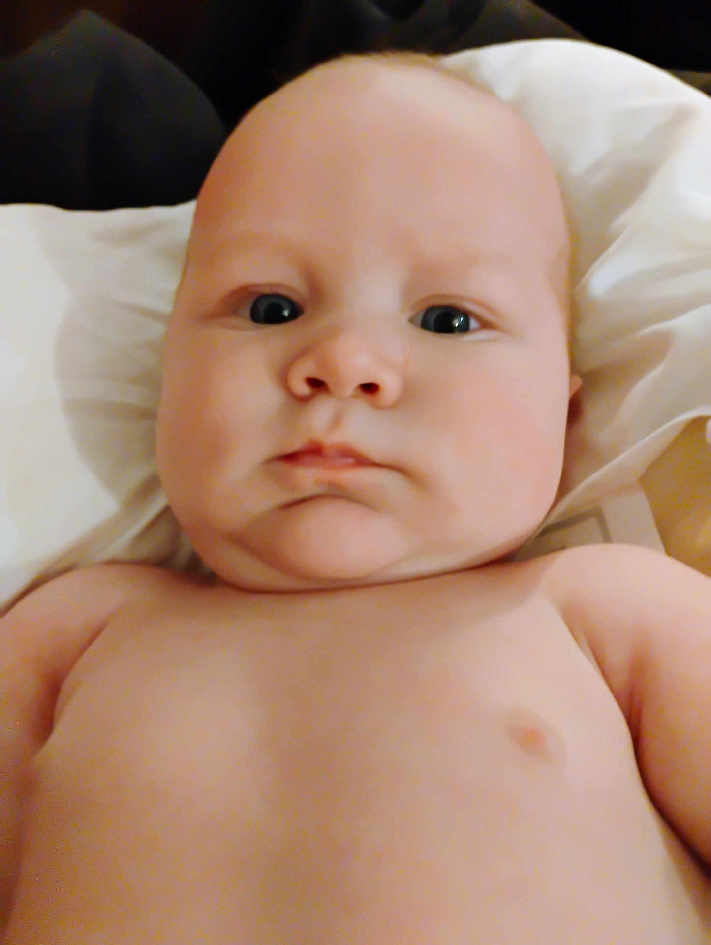 Joseph is registered to the contest to win money with this photo: baby, child, infant, face, skin, eyes, expression, closeup, portrait, naked_torso, lying_down, soft_light, head, young, cute, indoors, person, human, chubby, newborn