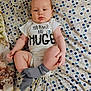 baby, infant, onesie, socks, blanket, polka_dots, child, lying_down, cute, expression, skin, head, face, legs, arms, clothing, indoor, soft_fabric, pattern, small_child