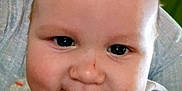 Joseph is registered to the contest to win money with this photo: baby, close_up, face, smile, drool, infant, cute, child, striped_clothing, cheeks, eyes, person, portrait, happy, indoors, head, skin, young_child, cozy, expression