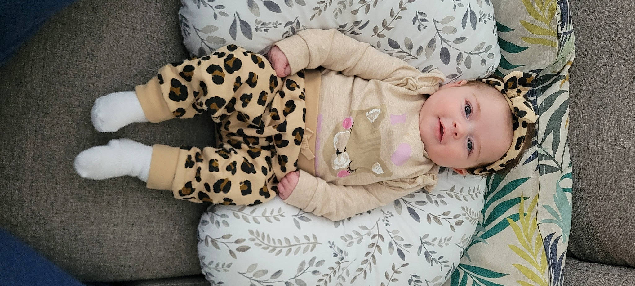 Isla is registered to the contest to win money with this photo: baby, baby_toddler_clothing, blond, child, comfort, couch, fur, hand, head, headwear, leg, linens, mammal, pattern, person, pink, sitting, skin, sleeve, thigh