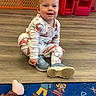 Ellie joined the competition — help win amazing prizes! carpet, child, colorful, cute, dinosaur, floor, footwear, happy, indoor, pajamas, person, playroom, rug, shoe, sitting, smiling, toddler, toy, wooden_floor, young_child