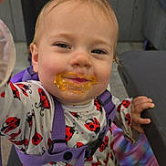Ellie joined the competition — help win amazing prizes! child, clothing, cute, daylight, face, food_on_face, hand, happy, ladybug_pattern, messy, outdoor, person, playful, portrait, purple_straps, seat, smiling, table, toddler, young_child