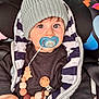 baby, child, pacifier, knit_hat, striped_jacket, car_seat, wooden_beads, clothing, cute, infant, hand, face, eyes, warm, seatbelt, closeup, indoors, expression, wearing, portrait