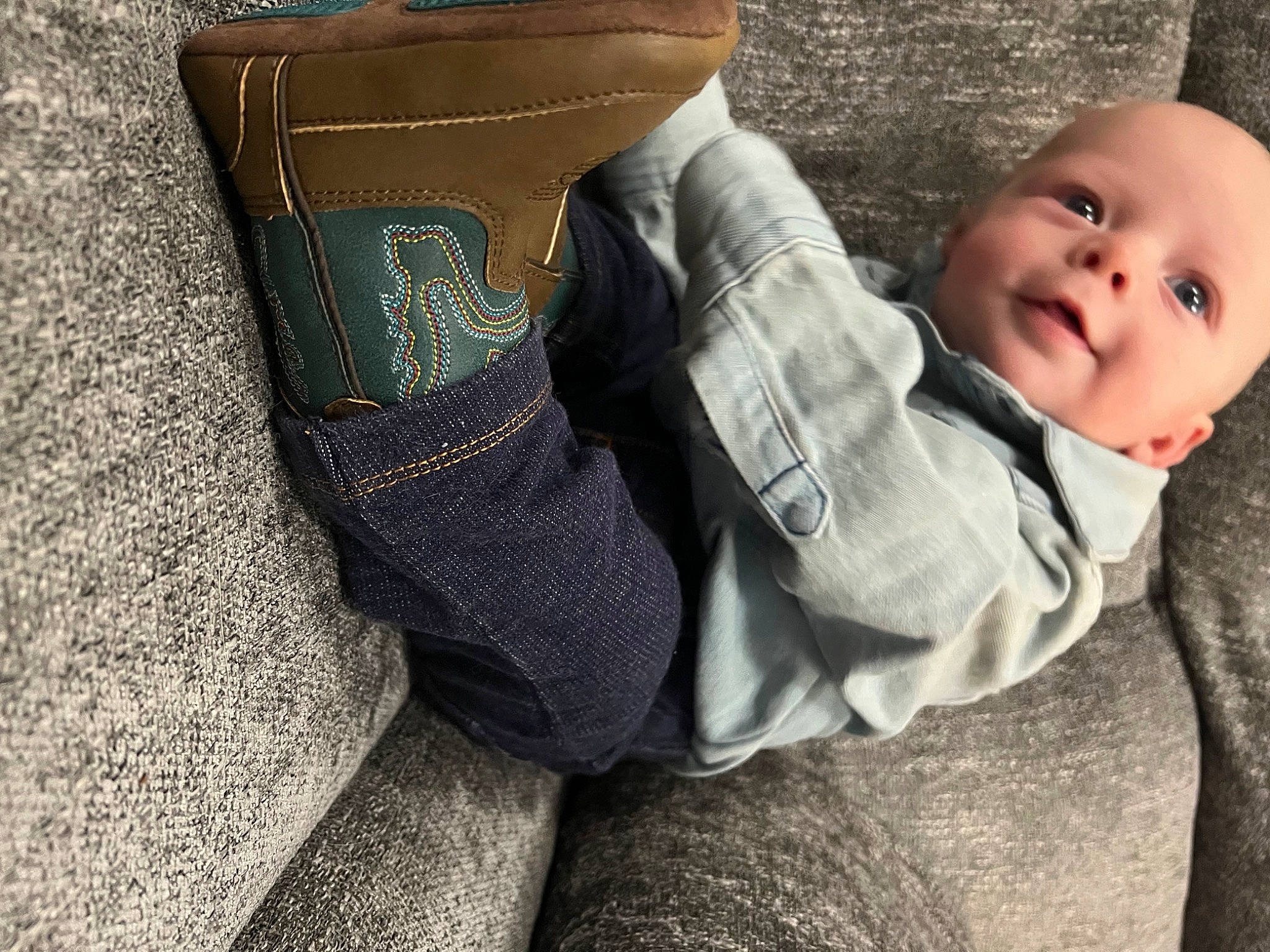 Casey is registered to the contest to win money with this photo: baby, baby_toddler_clothing, child, comfort, couch, flooring, foot, human_body, human_leg, knee, leg, linens, pattern, person, sitting, skin, smile, textile, thigh, toddler