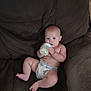 Casey is registered to the contest to win money with this photo: baby, bottle, diaper, couch, infant, child, sitting, drink, furniture, indoor, cute, relaxed, person, skin, leg, foot, hand, head, face, expression