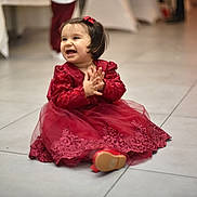 Adriana participe au concours pour gagner de l'argent avec cette photo : baby, bow, celebration, child, clapping, cute, dress, floor, girl, happy, human, indoors, party, person, portrait, red_dress, sitting, smiling, tile_floor, toddler