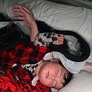 Talia joined the competition — help win amazing prizes! child, sleeping, pajamas, red, black, blanket, pillow, bed, cozy, rest, peaceful, indoor, person, relaxation, clothing, face, hair, comfort, toddler, nap