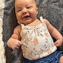 Laila joined the competition — help win amazing prizes! baby, infant, smile, happy, child, clothing, tank_top, shorts, blanket, fabric, pattern, floral, cute, portrait, skin, face, arms, lying_down, soft_texture, indoor