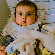 Adab is registered to the contest to win money with this photo: baby, blanket, child, cozy, cushion, cute, expression, face, indoors, infant, pattern, pillow, portrait, seat, soft_texture, star_pattern, striped_clothing, toddler, wide_eyes, young