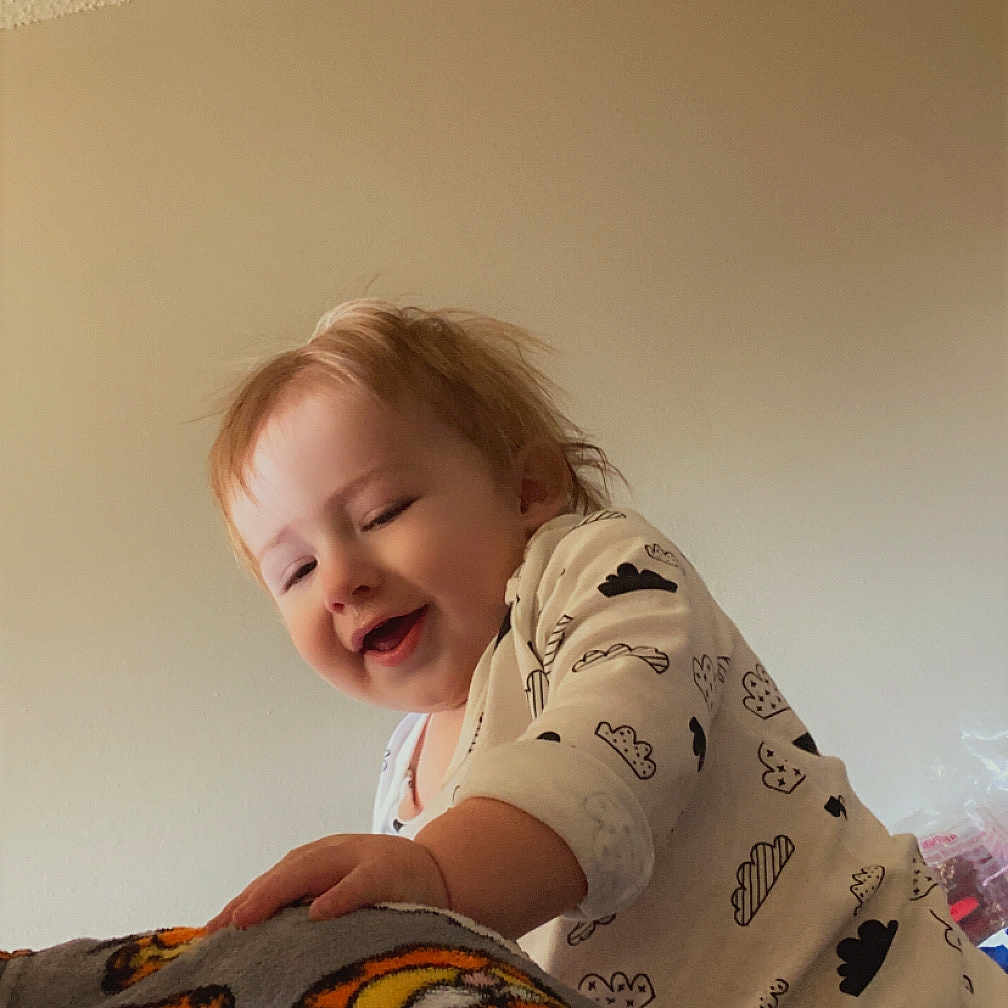 Arlo is registered to the contest to win money with this photo: animal, baby, babylaughing, blanket, bodypart, clothing, face, finger, hand, happy, head, homedecor, laughing, person, photography, portrait, quilt, smile, t_shirt, tiger