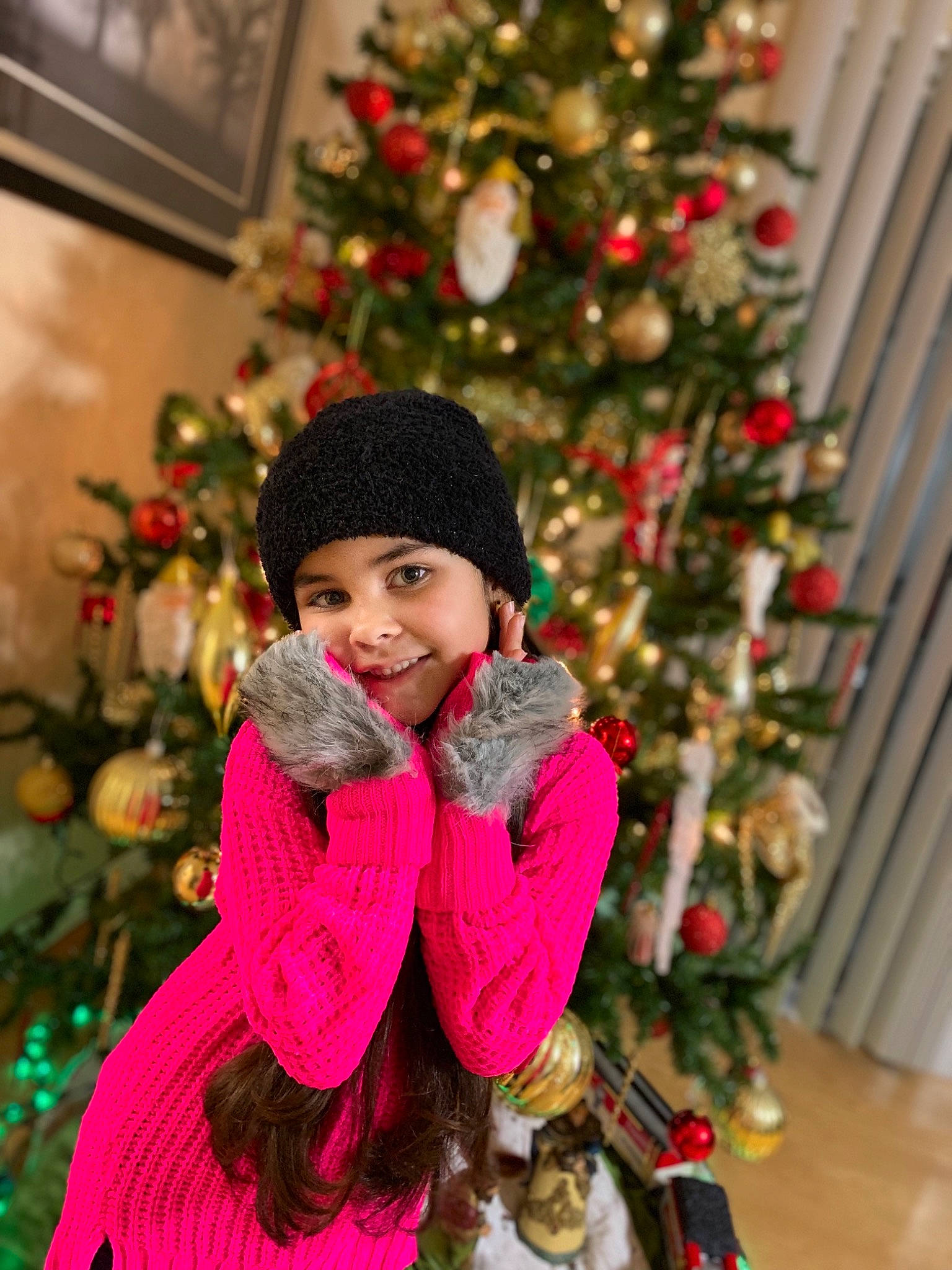 Stephanie is registered to the contest to win money with this photo: child, christmas, christmas_decoration, christmas_eve, christmas_ornament, christmas_tree, daughter, event, fur, holiday, interior_design, joy, outerwear, person, plant, smile, toddler, tradition, tree, winter