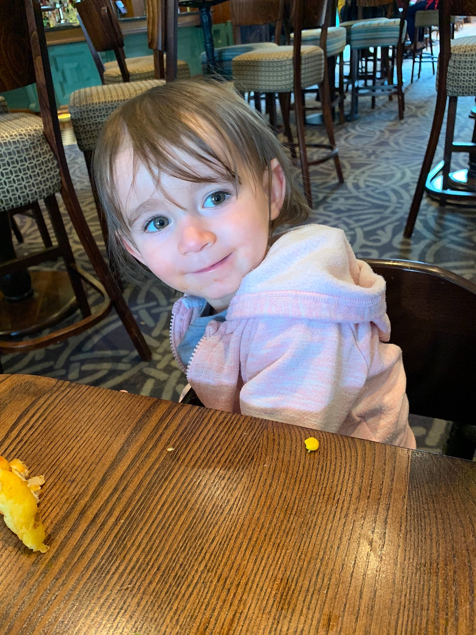 Isla joined the competition — help win amazing prizes! baby, child, drink, eating, floor, flooring, fun, hardwood, person, play, restaurant, sitting, toddler, vacation, wood
