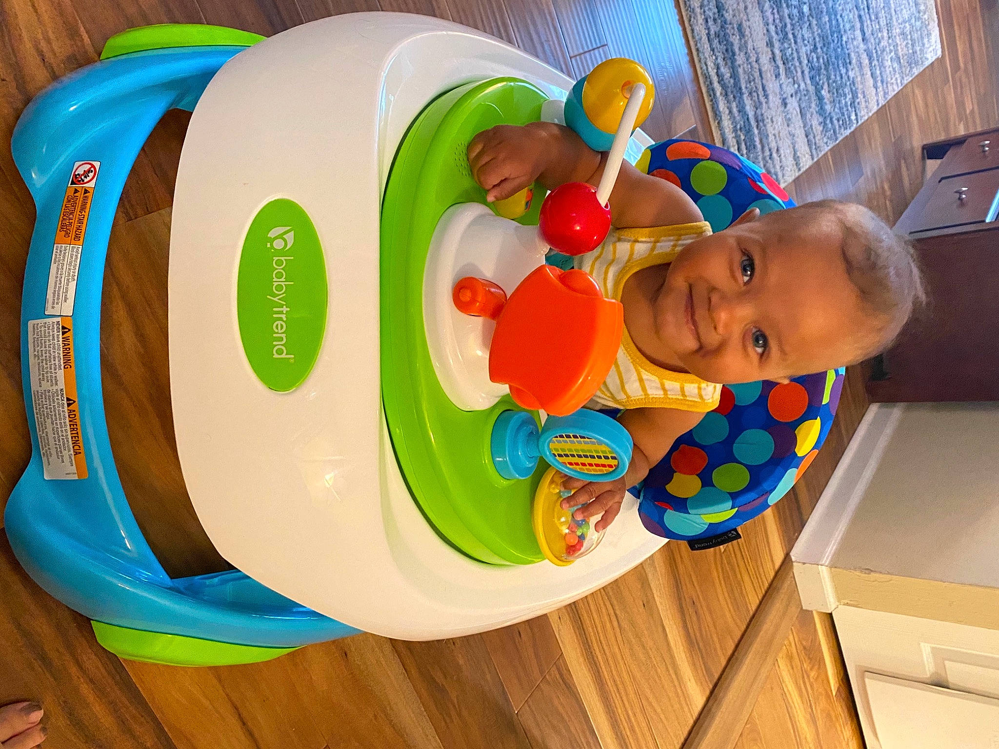 Roman is registered to the contest to win money with this photo: baby, baby_playing_with_toys, baby_products, baby_toys, cabinetry, child, fun, hardwood, joy, orange, party_supply, person, plastic, play, product, room, smile, toddler, toy, wood