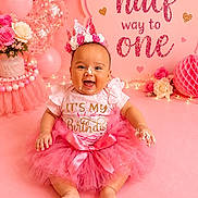 Alaina is registered to the contest to win money with this photo: baby, birthday, pink, tutu, crown, cake, frosting, celebration, smiling, sitting, balloons, flowers, decorations, party, infant, happy, girl, festive, indoors, portrait